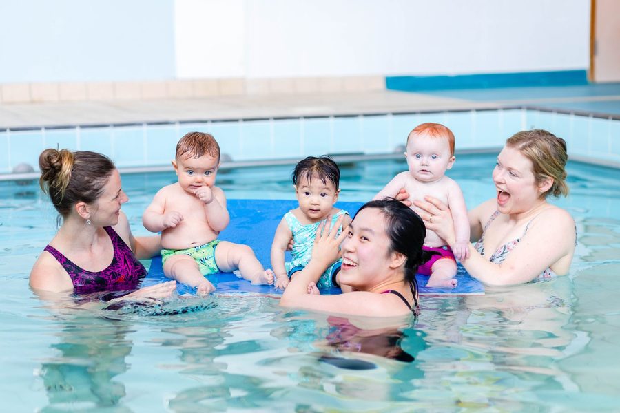 Babies and parents enjoying a Baby Squids swim class
